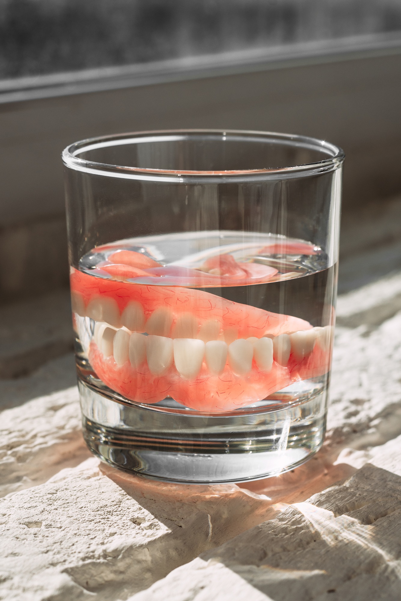 Prosthesis in a glass with a solution. Dental prosthesis care